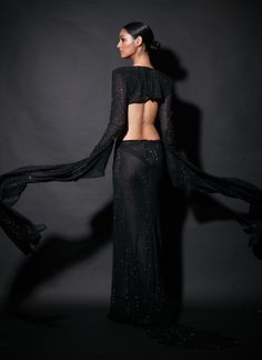 Editor's Note When looking for a black gown, stop here and choose this embellishments laden cutout gown. Fabric: Net Color: Black Neckline: V-plunge Sleeve type: Full Component: Gown Occasion: Cocktail and party Care: Dry Clean Only About the Designer Itrh makes a high-end luxury Indian ethnic wear made using exquisite and endangered age-old crafts such as kalamkari, madhubani, chikankari, zardozi, and gota weaving. The focus of the house is to cherish the beauty of handcrafted luxury designer w Blouse Yoke, Cutout Gown, Ladies Gown, Gowns Online, Black Gown, Indian Ethnic Wear, Designer Wear, Flared Sleeves, Asian Fashion