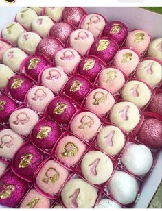 pink and gold decorated cookies in a box with the letter g on it's side