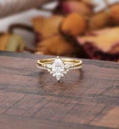 a diamond ring sitting on top of a wooden table