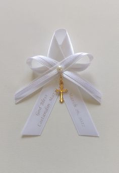 a white ribbon with a cross on it