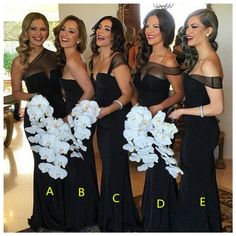 four beautiful women in black dresses posing for the camera with white flowers on their bouquets