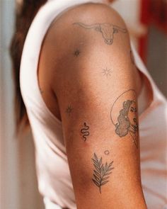 a woman with tattoos on her arm holding a cell phone