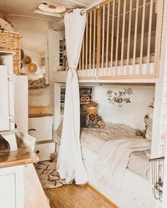 a bedroom with a bunk bed and white curtains