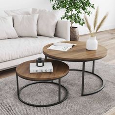 two coffee tables sitting on top of a rug in front of a couch and table