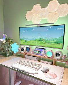 there is a computer monitor and keyboard on the desk in front of the television screen