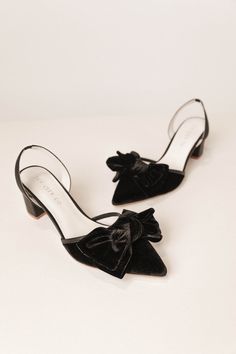 Elevate your style with the Eloise Black Bow Heel. Crafted from smooth black velvet and featuring a closed-toe design, these shoes provide timeless luxury with an elastic stretch strap against the back of the heel for stability and comfort. Step out in confidence with our first ever Ivy SHOES. Available in sizes 5.5, 6, 6.5, 7, 7.5, 8, 8.5, 9, 9.5, 10, + 10.5 & matching minis!! bow heel, womens shoe, wedding shoes, black heels, black bow, bow, elegant shoe, bridesmaid shoes, slingback heel Black Slingback Pumps With Ankle Strap For Gala, Black Ankle Strap Slingback Pumps For Gala, Velvet Heels For Party, Velvet Heels For Evening, Velvet Evening Heels, Elegant Velvet Heels For Formal Occasions, Black Pointed Toe Slingback Pumps For Gala, Black Low Heel Slingback Pumps With Reinforced Heel, Black Suede Slingback Pumps With Pointed Toe