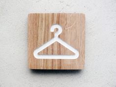 a wooden button with a white hanger on it