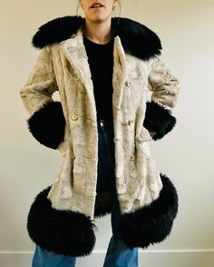 This is such an epic coat! This vintage beauty is a super unique Union Made Penny Lane style coat with an unusual black and cream color way! A faux fur cream bodice with plastic gold and cream buttons and a beautiful black long faux fur collar, wrists, and bottom trim. The inside has the originals owners name embroidered inside for an extra special touch "Dee Dee Deb" . This coat is in excellent vintage condition.  Best fits Womens size M Shoulder to shoulder: 15.5" Pit to pit: 19" Pit to wrist: 16" Waist: 18.5" Length: 36" My sizing is an estimate of general modern day sizing and vintage sizes vary and are different from current, modern day sizing. Please see measurements above to get the most accurate sense of fit.  All of my measurements are taken with the garment lying flat, so please Cream Long Fur Coat With Faux Fur Lining, Vintage Cream Fur Coat With Faux Fur Trim, Vintage Long Beige Fur Coat, Vintage Cream Fur Coat For Winter, Cream Vintage Fur Coat For Winter, Vintage Beige Long Fur Coat, Vintage Beige Long Sleeve Fur Coat, Fitted Cream Fur Coat With Faux Fur Trim, Cream Fitted Fur Coat With Faux Fur Trim