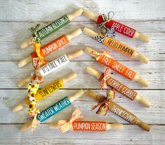 six wooden rolling pins with different types of candy and sayings on them, tied together