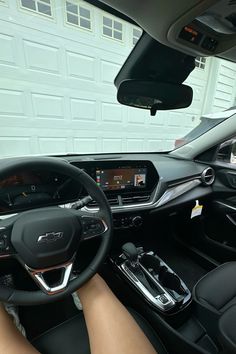 the interior of a car with dashboard, steering wheel and display screen showing information about cars