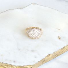 Complete your look with our sparkly domed pavé ring. Adorned with over 100 clear crystals, this ring was designed to match our Rhinestone Apple Watch Bands and to pull together your polished style. We particularly love this ring for cocktail parties...upgrade every moment! Brass ring with gold or silver plating Arrives in a Goldenerre muslin bag, perfect for gifting Imported Glamorous Sparkling Diamond Ring, Glamorous Rings With Sparkling Stones, Glamorous Bling Crystal Rings, Classic Party Rings With Sparkling Stones, Glamorous Round Diamond Ring With Sparkling Stones, Glamorous Sparkling Promise Ring, Party Diamond Ring With Pave Setting In Cubic Zirconia, Party Rings With Pave Setting In Diamond White, Dazzling Dome Ring With Pave Setting For Wedding