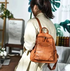 Step up your fashion game with this stylish ladies' backpack. Crafted from genuine leather, this waterproof backpack is both practical and fashionable. It features a soft handle strap for comfortable carrying and offers ample interior and exterior pockets, including a convenient silt pocket. Handmade with attention to detail, this vintage-inspired backpack is a must-have accessory for any fashion-forward woman.SpecificationsBrand Name: GeraldBlack Origin: Mainland ChinaCN: GuangdongMain Material: Genuine LeatherGenuine Leather Type: Cow LeatherLining Material: Organic CottonBackpacks Type: SoftbackInterior: Cell Phone PocketInterior: Interior Zipper PocketHandle/Strap Type: Soft HandleExterior: Silt PocketDecoration: NONEClosure Type: zipperTechnics: EmbossingCapacity: Below 20 LitreItem T Casual Leather Backpack For On-the-go, Large Capacity Standard Backpack, Back To School Softback Shoulder Bag, Casual Leather Backpack With Large Capacity, Casual Leather Backpack With Zipper For Back To School, Casual Leather Softback Backpack For On-the-go, Leather Backpack For Travel, Fall Season, Trendy Leather Backpack For Fall, Fall Satchel Backpack For Daily Use