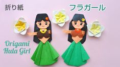 two origami hula girl cut out of paper on a pink background with japanese characters