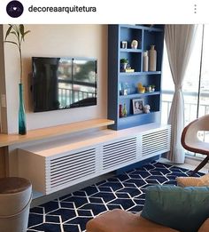 a living room filled with furniture and a flat screen tv on top of a wall