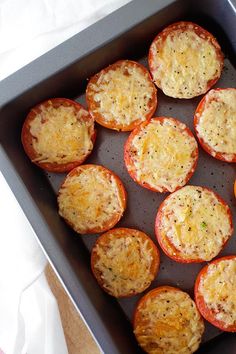 several mini pizzas in a pan on a table