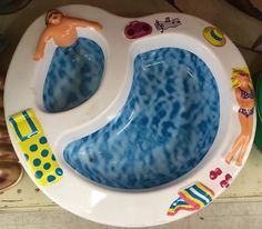 a child's potty seat with an image of a man swimming in it