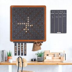 a wooden table topped with a blackboard and lots of magnets on the wall