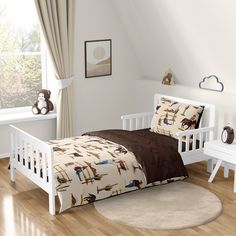 a child's bedroom with white furniture and wooden floors