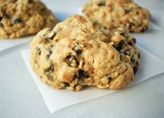 three cookies sitting on top of white paper