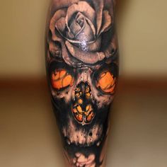 a man's leg with a skull and rose tattoo on it