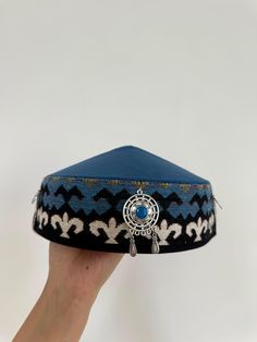 This stunning Kazakh & Kyrgyz headdress is a traditional piece of clothing worn in Central Asia, particularly in Kazakhstan and Kyrgyzstan. It is an important part of the region's cultural heritage, and has been worn by women for centuries. Made with high-quality materials and featuring intricate embroidery and beadwork, this headdress is a true work of art. The design is inspired by the Silk Road, the ancient trade route that connected China to the Mediterranean. The headdress is adorned with c Festival Headband, The Silk Road, Cultural Festival, Silk Road, Intricate Embroidery, World Cultures, Central Asia, Turbans, Cultural Heritage