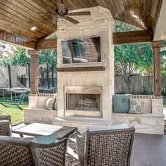 an outdoor living area with furniture and a fireplace