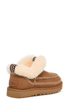 A plush genuine shearling collar displays signature UGG coziness on this low-profile suede bootie marked with decorative stitching and lined in UGGplush, a moisture-wicking textile made from a wool-rich blend but crafted to feel and wear like genuine shearling. 1 1/4" platform Cushioned footbed Leather and genuine shearling upper/UGGplush wool-blend lining/synthetic sole Shearling may be sourced from Australia, Ireland, Spain, the UK or the USA. See packaging for confirmed country of origin Impo New Uggs, Ugg Classic Ultra Mini, Fabric Gift Bags, Suede Booties, Womens Uggs, Nordstrom Store, Free Fabric, Fabric Gifts, Chestnut