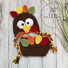 a crocheted turkey hat on top of a wooden table