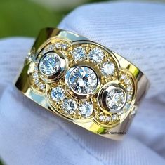 a gold ring with three diamonds on it