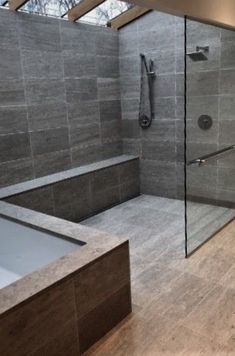 a bathroom with a large walk in shower next to a bathtub