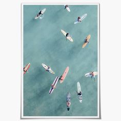 an aerial view of people on surfboards in the water