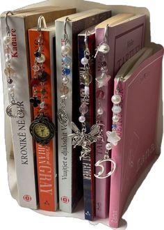 the bookend is holding several books with charms on them