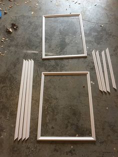 three frames sitting on top of a floor next to each other