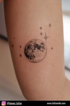 a woman's arm with a tattoo on it that has the moon and stars