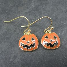 These beautiful estate earrings are gold plated. They feature enamel jack o lanterns. Measurements: 1/2 by 1 inch from the top of the earwire Condition: New old stock / never worn These earrings have been steam cleaned and sanitized. They are non returnable. Gold Novelty Earrings For Halloween, Nickel-free Novelty Gold Earrings, Vintage Halloween Earrings As Gift, Vintage Earrings For Halloween Gift, Nickel-free Gold Novelty Earrings, Novelty Gold Nickel-free Earrings, Handmade Gold Halloween Earrings, Gold Novelty Pierced Earrings, Handmade Gold Earrings For Halloween