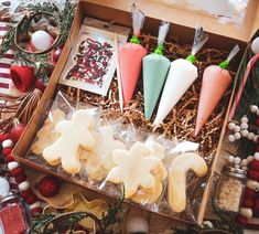 an open box filled with cookies and other holiday treats on top of a wooden table