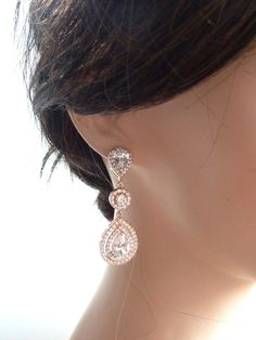 This earring features a clear white teardrop cubic zirconia surrounded by 2 layers of little cubic zirconia gems (about 60 gems around it),  dangle from a rose gold plated halo round cubic zirconia and a LARGE pear shaped cubic zirconia post earrings. Size: 5.3 (L) x 1.8  (W) cm or 2.1(L)  x 0.72  (W) inches long. Matching Bracelet and Necklace: https://www.etsy.com/listing/225770378/bridal-bracelet-double-halo-round-rose Rose Gold Teardrop Cubic Zirconia Earrings, Rose Gold Cubic Zirconia Teardrop Earrings, Rose Gold Cubic Zirconia Drop Bridal Earrings, Long Bracelet, Double Halo, Matching Bracelet, Bridal Bracelet, Clear White, Matching Bracelets