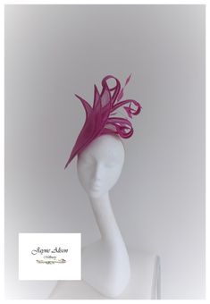 ''Stunning hatinator in Heather pink, pale fuchsia  sinamay.   3 large petals create a striking effect whilst the elongated petals curl and twist to create a beautiful shape.  A cluster of coq feathers create movement as they dance in the breeze on this simply elegant headpiece. Sits on a headband. This item has sold, however, similar pieces can be made in a variety of colours.  Please ask for details.  As every piece is handmade, some differences can occur from the photos listed on this site. Pink Wedding Hat With Structured Crown, Pink Fitted Hat With Structured Crown, Pink Sinamay Fascinator For Church, Pink Kentucky Derby Fascinator With Structured Crown, Pink Structured Crown Fascinator For Kentucky Derby, Pink Fascinator For Kentucky Derby With Structured Crown, Pink Fascinator With Short Brim For Formal Occasions, Pink Structured Crown Headpiece For Wedding, Pink Fascinator For Races With Pinched Crown