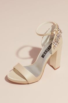 a pair of high heeled shoes with an ankle strap and jewel embellishment