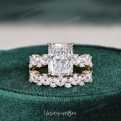 an engagement ring and wedding band set with a princess cut diamond surrounded by round brilliant diamonds