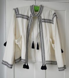 Riviera wedding? Stunning, chic and versatile woman's casual jacket. Inspired by bohemian embroidered Indian clothing, in monochrome colourway.  Ivory off-white and black detailing. Would look fabulous over black palazzo pants or summer dress alike. Dress up or dress down over jeans. I bought this for a wedding outfit and wore it only once. Medium size will fit 12 UK, plus or minus. 100% cotton, fully lined in cotton. White Tasseled Outerwear For Spring, White Spring Outerwear With Tassels, Festive White Cotton Outerwear, White Printed Summer Outerwear, White Long Sleeve Outerwear With Tassels, White Bohemian Handmade Outerwear, White Bohemian Embroidered Outerwear, White Embroidered Kimono For Beach Cover-up, Riviera Wedding