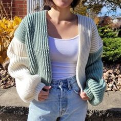 a woman standing in front of a brick wall