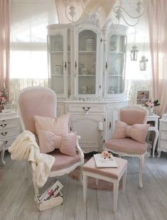 a living room filled with furniture and pink curtains