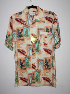 Vintage 1970's Novelty Print Disco Shirt by Martini.  New with tag.  Original retro shirt with French street scenes.  Rare and unique.  Size medium.  100% soft nylon. New Old Stock - unused condition. Tag: "Styled by Martini This knit luxury fabric has been created to offer the newest look in fashion always retaining its shape and full body richness." MEASUREMENTS Shoulder to Shoulder: 18" Underarm to Underarm: 21" Outer Sleeve Length (shoulder edge to cuff edge): 10" Top to Bottom Length (from Vintage Shirt With Graphic Print And Camp Collar, Vintage Multicolor Graphic Print Camp Shirt, Retro Camp Shirt With Graphic Print, Retro Collared Hawaiian Shirt, Vintage Short Sleeve Camp Shirt With Graphic Print, Vintage Short Sleeve Shirt With Graphic Print, Vintage Printed Camp Shirt With Camp Collar, Retro Fitted Hawaiian Shirt With Graphic Print, Retro Graphic Print Collared Hawaiian Shirt