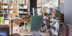 a bicycle is parked in front of a bookshelf with many books on it