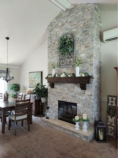 a living room filled with furniture and a stone fireplace