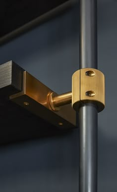 a close up of a metal pole with a gold lock on it's end