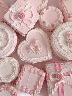 pink and white decorated heart shaped cookies in a box with bows, hearts, and flowers