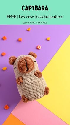 a small stuffed animal sitting on top of a colorful background with the caption capybara