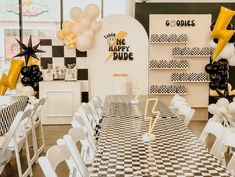 a black and white checkered table with balloons